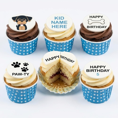 Set of six dog theme birthday cupcakes with puppy, paw print, bone, and custom message toppers in blue polka dot wrappers.