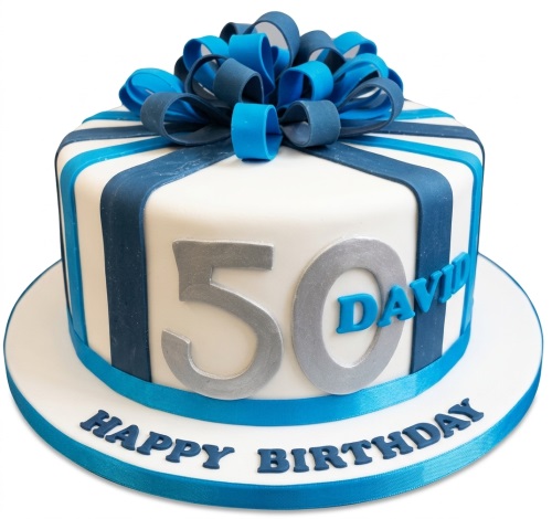 Round white birthday cake with blue ribbons, bow, silver custom age numbers, and a personalised name.