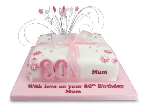 Elegant 80th birthday cake for Mum with pink flowers, '80' topper, and starburst decoration.