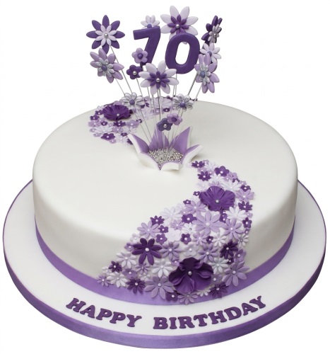White round cake with purple and white floral decorations and a custom age topper.