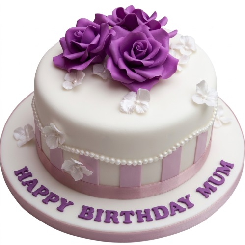 White birthday cake with purple sugar roses, white flowers, and a pearl border.