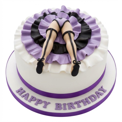 Round white birthday cake with purple and black ruffled skirt and edible legs with stockings and shoes.