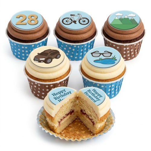 Cupcakes with chocolate and vanilla frosting, topped with edible designs of a '28' age, a bicycle, mountains, a brown car, glasses with a pond, and a 'Happy Birthday Howard' message.