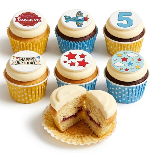 Assortment of kids birthday cupcakes with aeroplane, stars, clouds, and custom age topper designs.