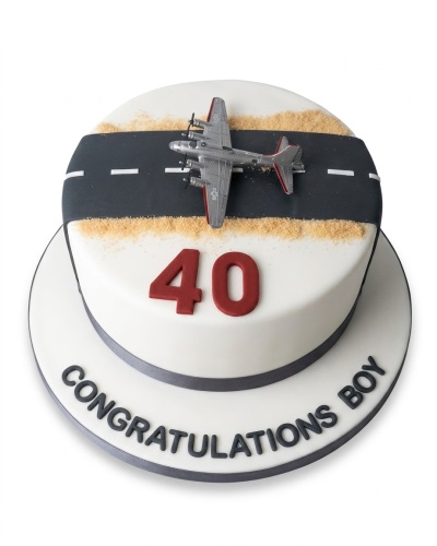 White round cake with a silver airplane on a black runway, red custom age number, and grey text.