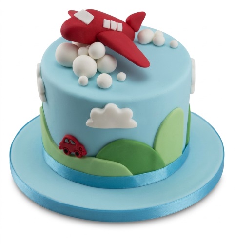 Blue birthday cake with a red airplane, white clouds, green hills, and a small red car.