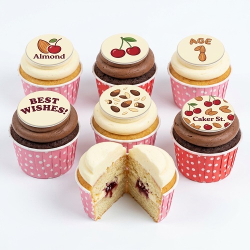 Cupcakes with white and chocolate frosting, topped with cherry and almond edible designs.