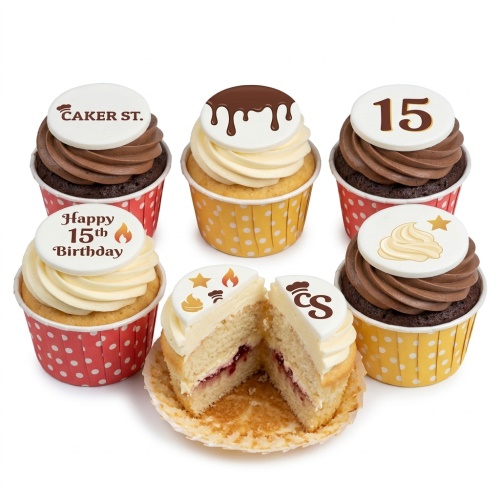 Assortment of birthday cupcakes with custom age and message toppers, in red and yellow polka dot cases.