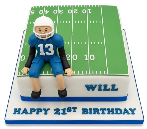 American football field birthday cake with a player figurine in a blue uniform.