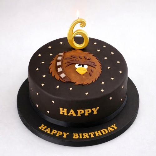 Round dark brown birthday cake with a cartoon Chewbacca design, gold stars, and a custom age candle.