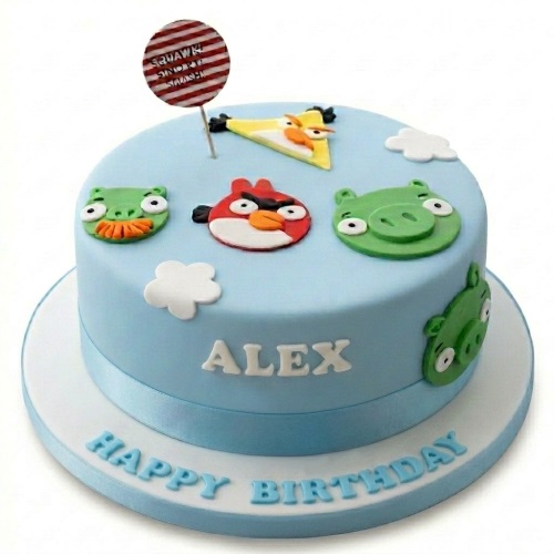Round light blue Angry Birds birthday cake with Red, Chuck, and green pig characters, white clouds, and a striped topper.