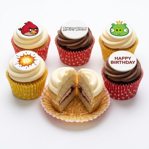 Angry Birds themed cupcakes with Red, green pig, and logo toppers, alongside a 'Happy Birthday' message cupcake.