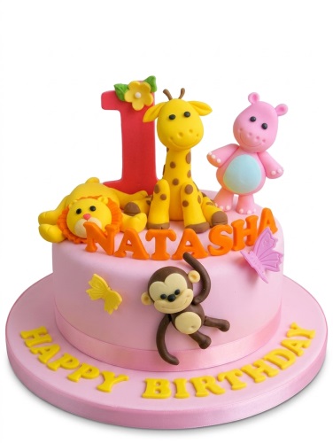 Pink jungle safari animal birthday cake with fondant lion, giraffe, hippo, and monkey figures.