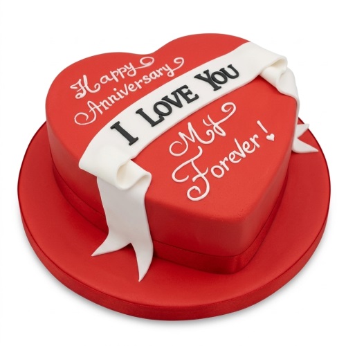 Red heart-shaped anniversary cake with white 'I Love You' ribbon and 'Happy Anniversary' message.