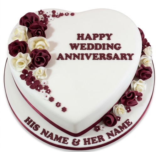 Heart-shaped white anniversary cake with red and cream fondant roses and floral decorations, with a custom message area for names.
