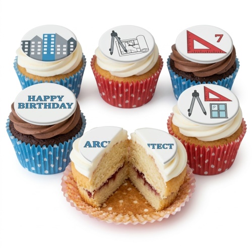 A selection of cupcakes with architectural themed edible toppers including buildings, blueprints, compasses, and a set square, with one saying 'Happy Birthday'.