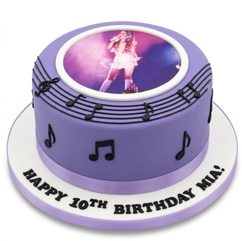 Round purple music theme birthday cake with edible photo of a female singer and black musical notes.