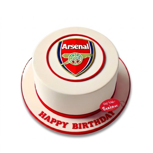 Round white birthday cake with a prominent red, blue, and gold Arsenal FC logo on top, with a red 'Happy Birthday' message on the cake board.