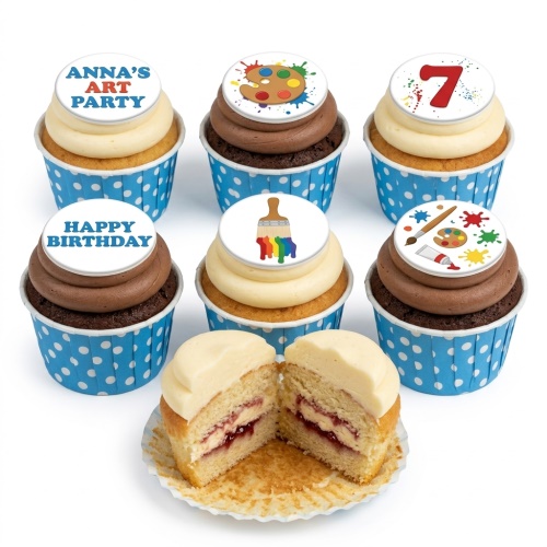 A selection of vanilla and chocolate cupcakes with art theme toppers including paint palettes, brushes, and a custom age '7' topper.