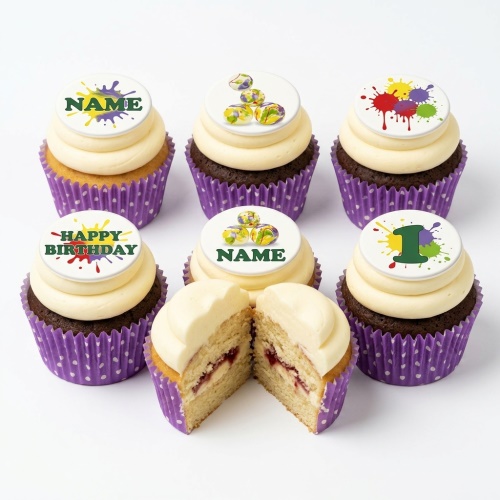 Colourful paint splatter birthday cupcakes with custom age and name toppers in purple cases.