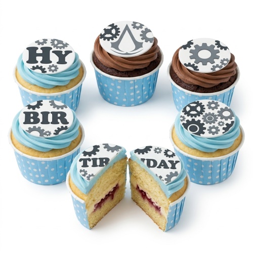 Assorted cupcakes with blue and chocolate frosting, topped with white edible discs featuring black gear designs and an Assassin's Creed logo.