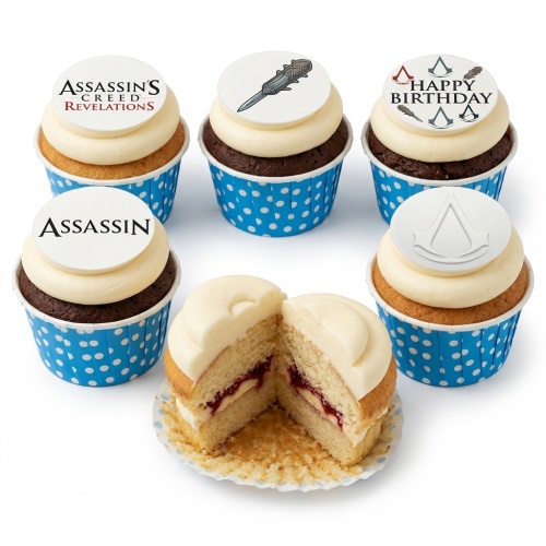 Set of Assassin's Creed themed cupcakes with white frosting, blue polka dot wrappers, and edible game logos including "Happy Birthday".