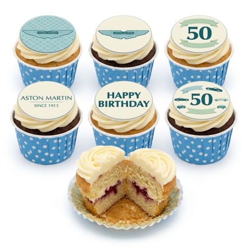 Aston Martin themed birthday cupcakes with car logos, 'Happy Birthday' message, and custom age '50' topper in blue polka dot cases.