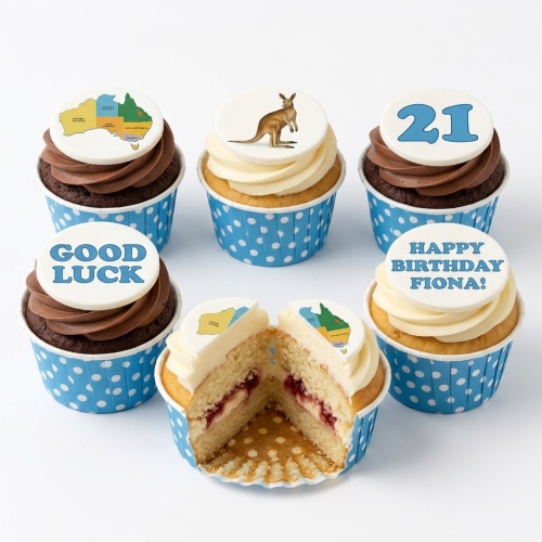 Set of Australia themed cupcakes with map, kangaroo, and custom message toppers in blue polka dot wrappers.