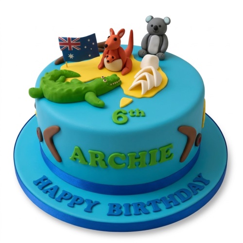 Blue fondant birthday cake with Australian animal figures, flag, and boomerangs, with a custom age and name.
