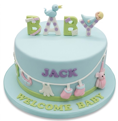 Light blue baby shower cake with 'BABY' topper, clothesline, baby items, and custom name.