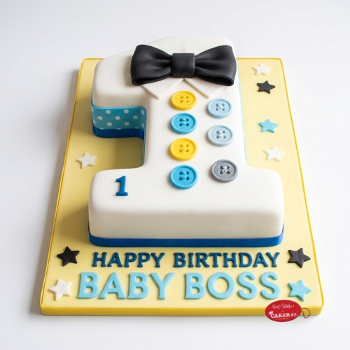 Baby Boss 1st birthday cake shaped like number one with a black bow tie, colourful buttons, and blue polka dots.