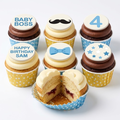 Cupcakes with blue and white frosting, decorated with a mustache, bow tie, stars, 'Baby Boss' and custom age toppers.