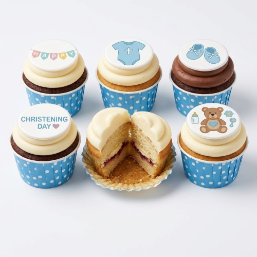 Assortment of blue and white Christening cupcakes with baby grow, booties, teddy bear, and 'Christening Day' toppers.