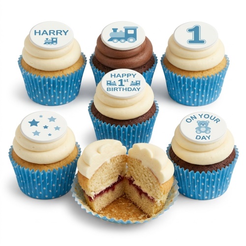 Baby boy 1st birthday cupcakes with train, stars, and teddy bear toppers.