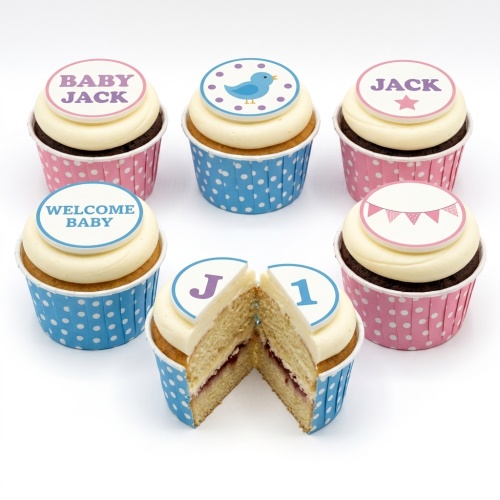 Assortment of baby shower cupcakes with pink and blue designs, bird, bunting, and custom messages.