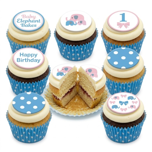 Close-up of baby elephant and polka dot cupcakes with '1' and 'Happy Birthday' toppers in blue and pink.