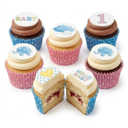 Assortment of baby shower cupcakes with elephant, cloud, heart, 'BABY', and 'HELLO BABY' toppers in pastel colours.