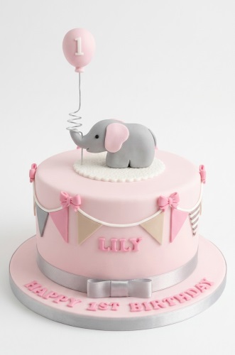 Pink 1st birthday cake with grey elephant, pink balloon with '1', bunting, and personalised name.