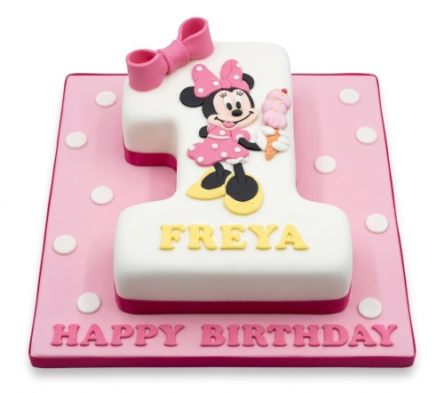 Minnie Mouse Number 1 shaped birthday cake with pink bow, polka dots, and Minnie holding an ice cream.