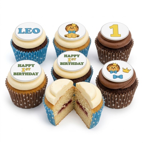First birthday cupcakes with lion, number one, and 'Happy 1st Birthday' toppers.