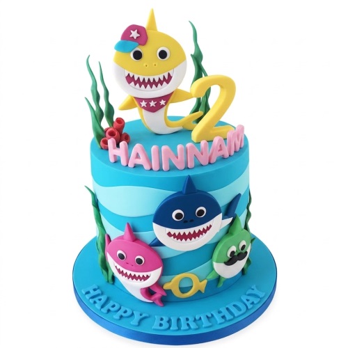 Blue Baby Shark birthday cake with Baby Shark characters, seaweed, coral, custom age topper, and personalised name.
