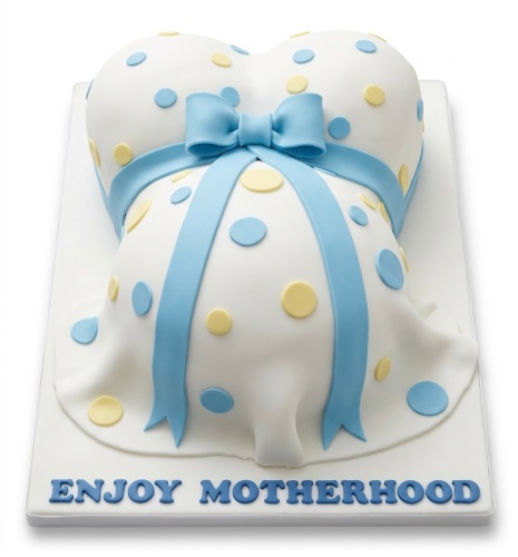 White pregnant belly cake with blue and yellow polka dots and a blue ribbon.