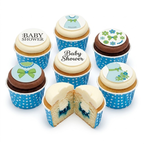 Baby shower cupcakes in blue and white polka dot cases, with 'Baby Shower' and baby dress toppers, and a visible blue filling.