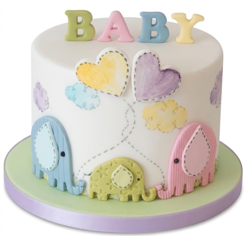 White baby shower cake with pastel elephants, hearts, clouds, and "BABY" letters.
