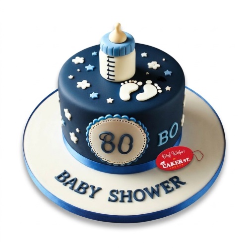 Dark blue baby shower cake with a baby bottle topper, white baby footprints, stars, and clouds.