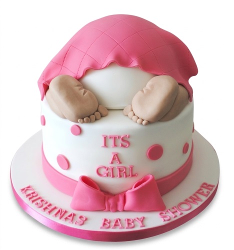 White baby shower cake with pink polka dots, a pink bow, and baby feet on top, with 'It's a Girl' message.