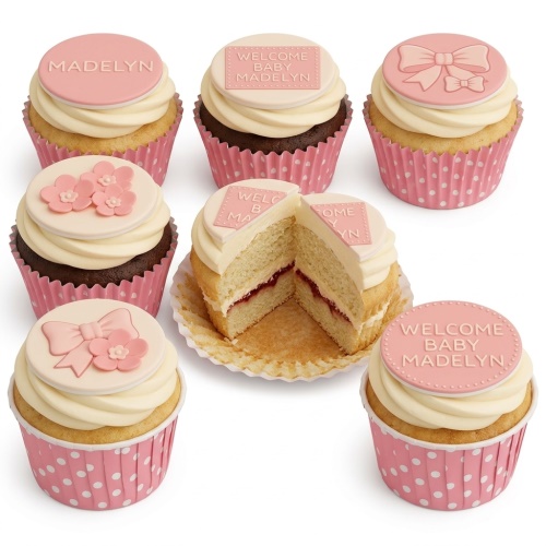 Pink and cream baby shower cupcakes with bows, flowers, and 'Welcome Baby' message toppers.
