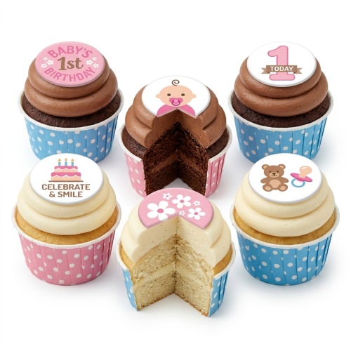 Assortment of 1st birthday cupcakes with baby, teddy, dummy, and cake toppers in pink and blue.