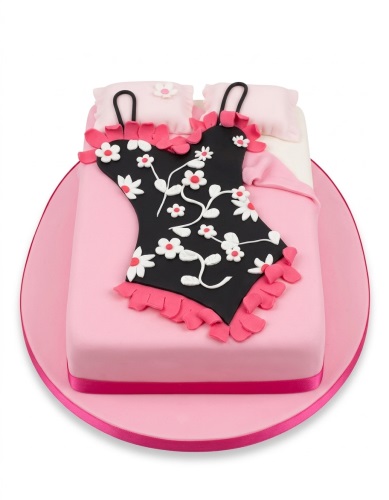 Pink cake designed as a bed with a black nightdress decorated with white and pink flowers.