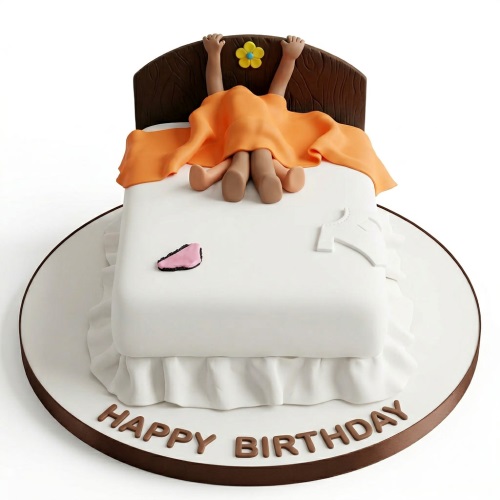 Funny bed theme birthday cake with figures under a blanket, bra, and shirt